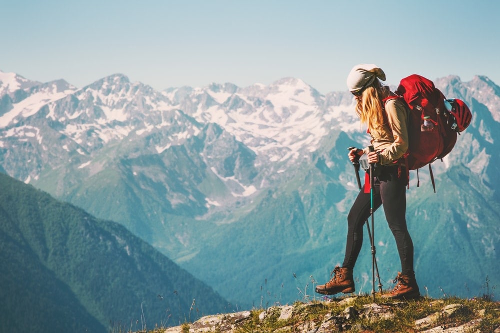 A woman hiking with a red backpack