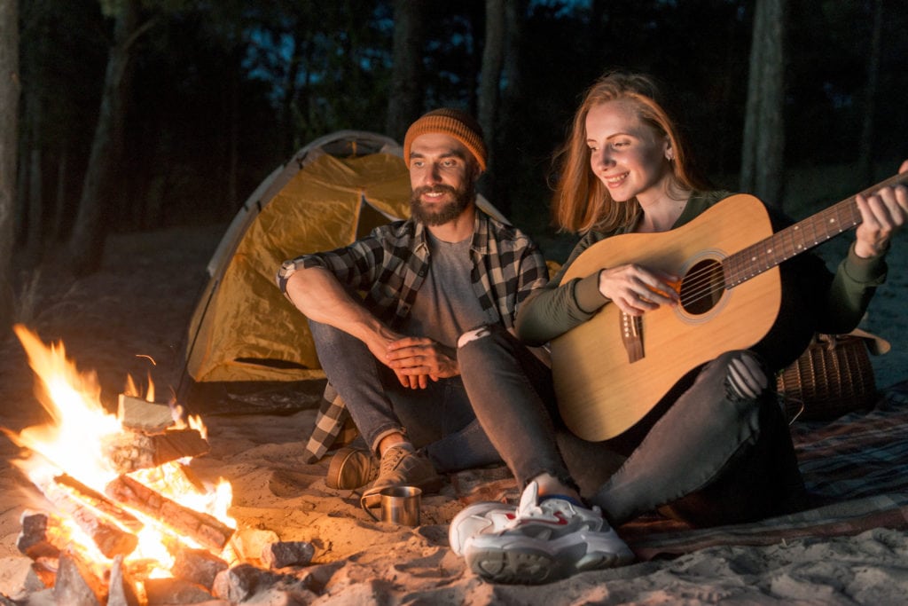 Campfire with a couple singing together
