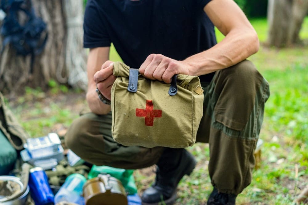 A man holding an emergency kit