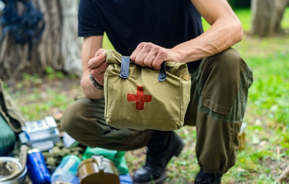 image of a man picking up a first aid kit