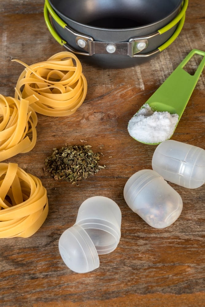 Mini plastic containers and spices on a wood table