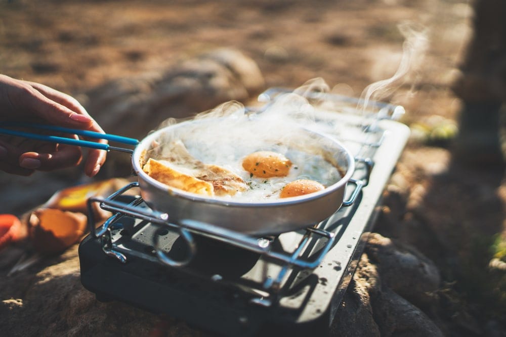Man cooking eggs on a frying pan