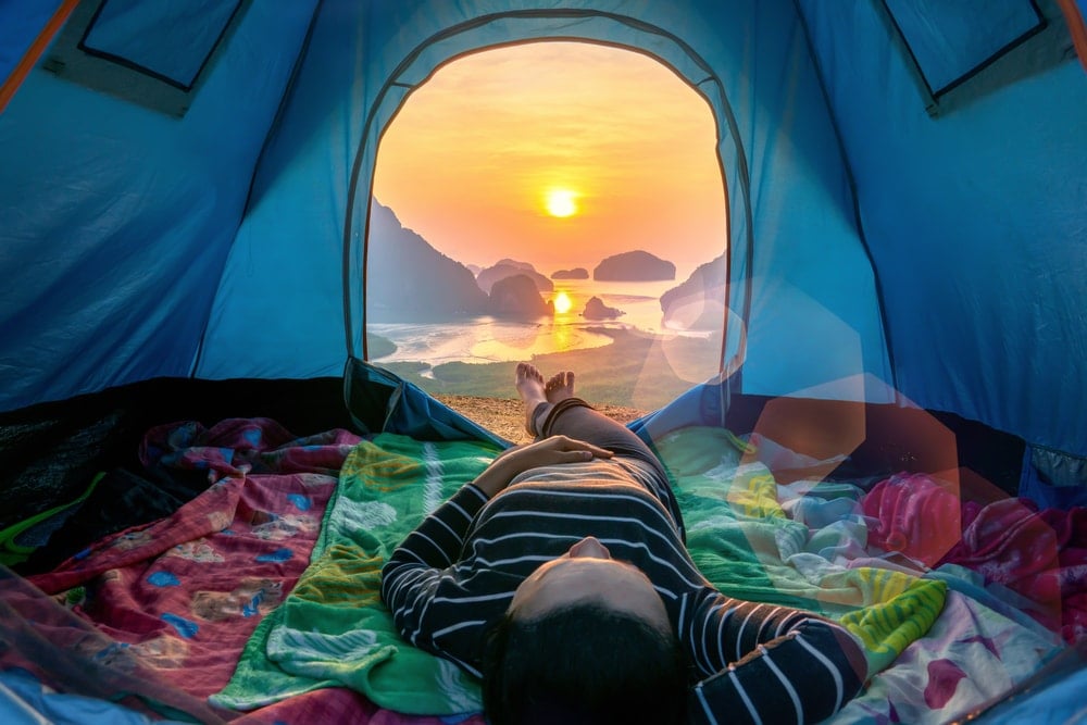Person lying inside her camping tent