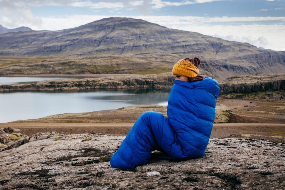 Woman staying warm inside a sleeping bag