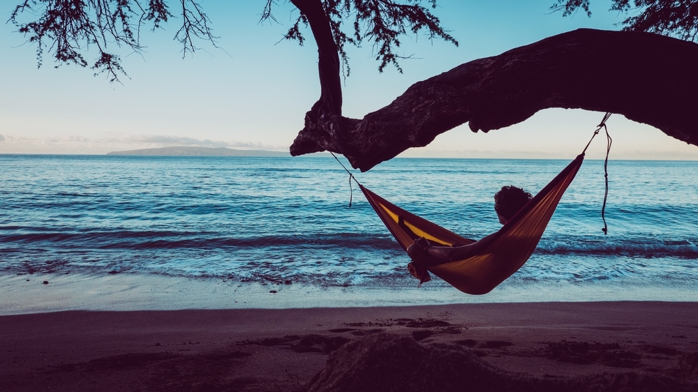 Man looking at the beach while in the hammock