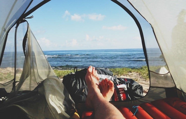 a man resting with a view inside of a tent 