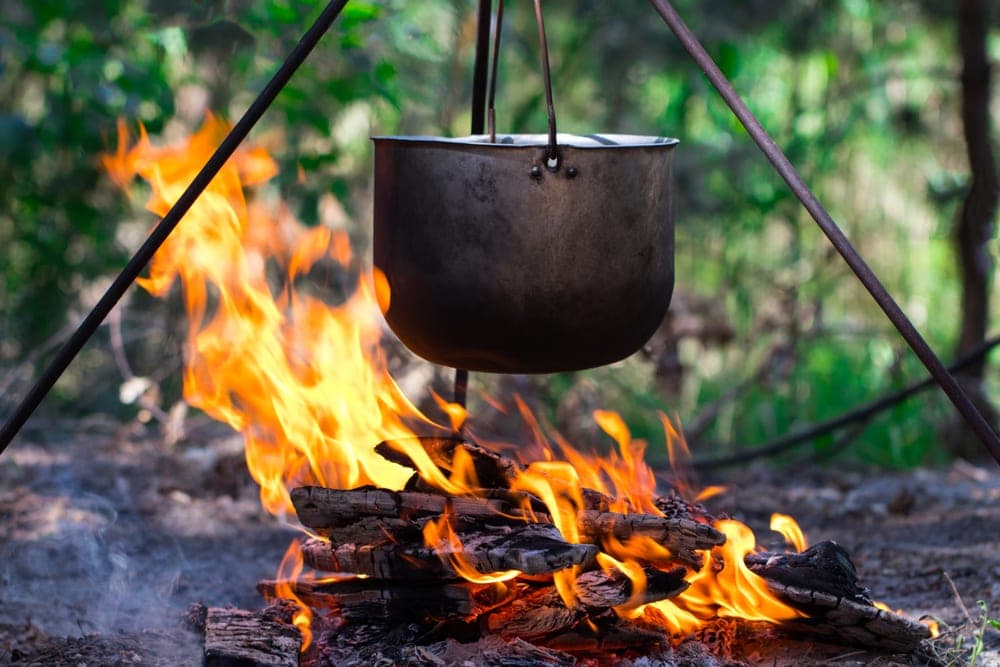 Pot over a campfire to boil water while camping