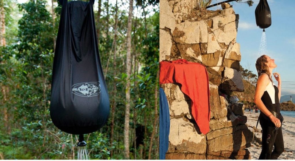 Woman showering using a camping solar heater