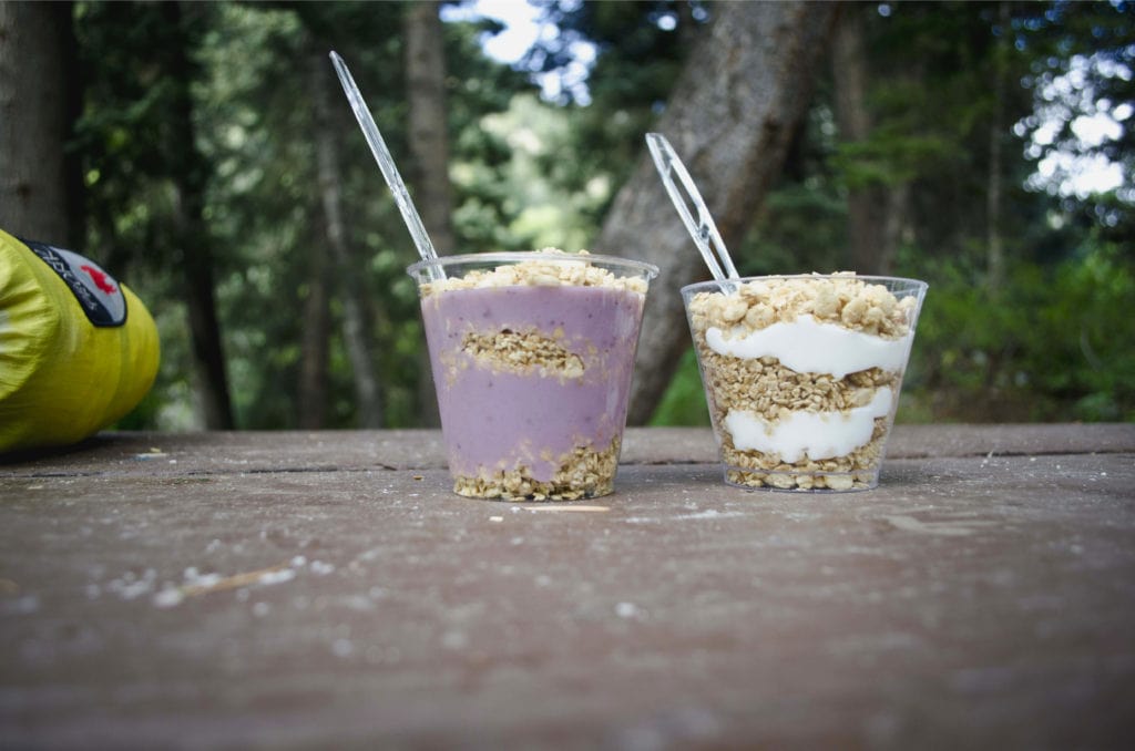 Yogurt and Granola displayed on the table as camping food