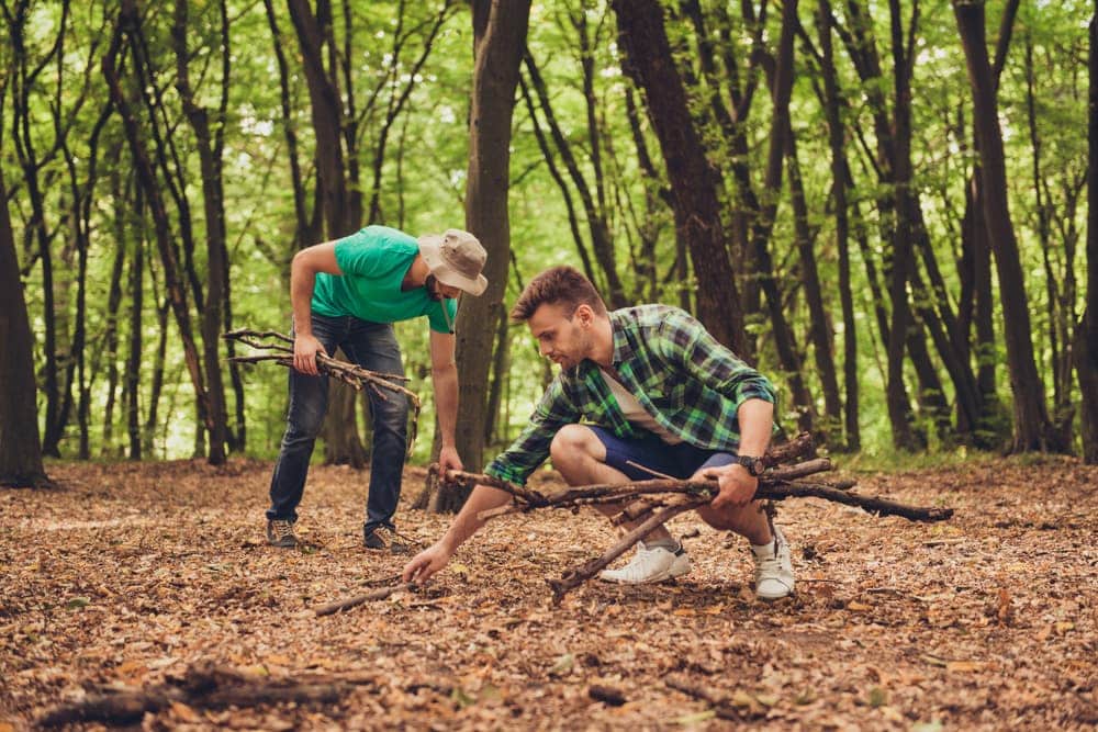 Men collecting firewood while camping