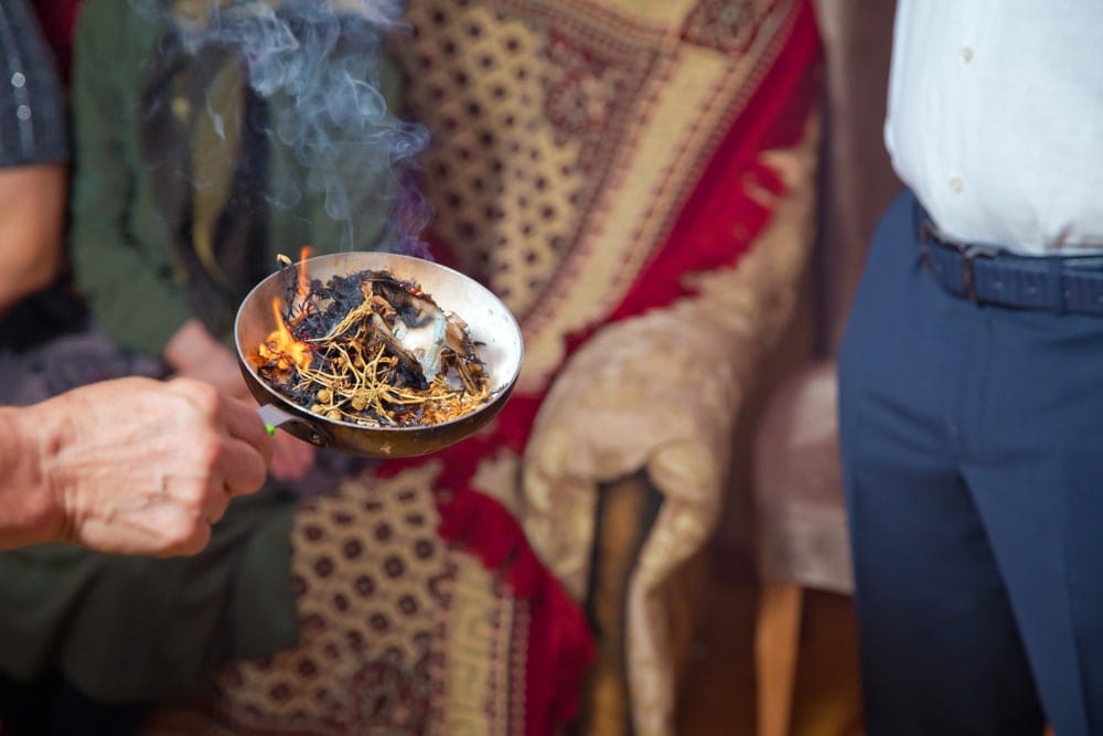 Hand holding an incense