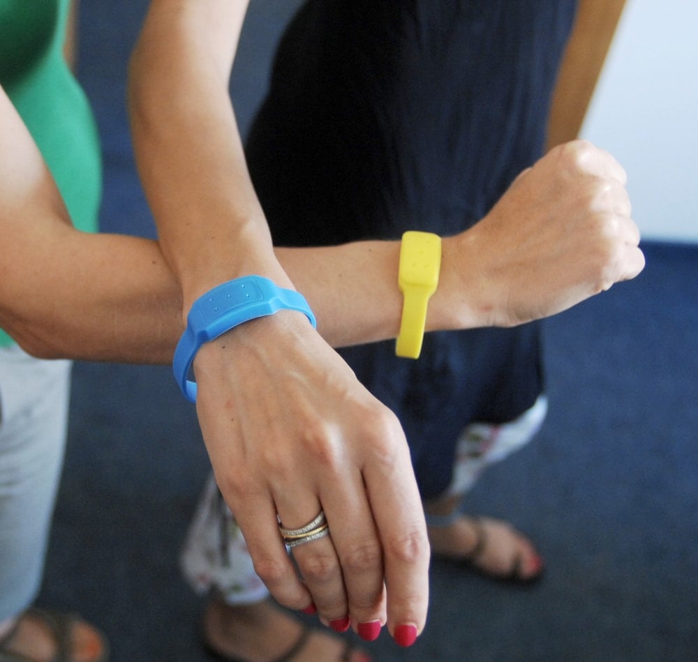 Arms wearing mosquito bracelets