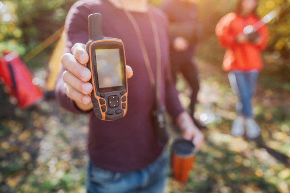 Man holding a communication device for hiking