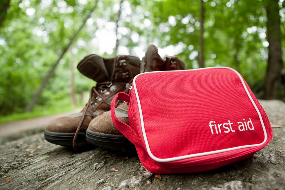 First aid kit and a hiking boots