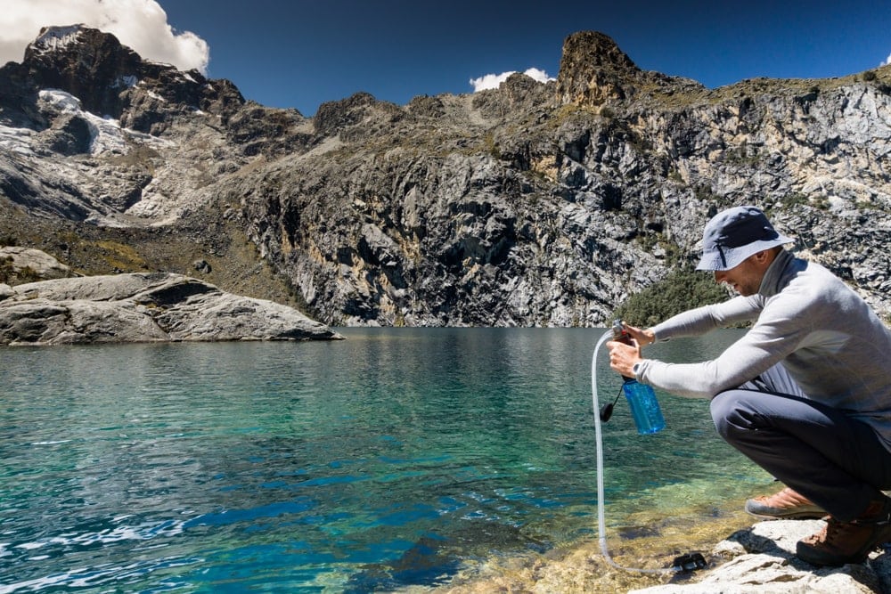 Man getting water from a lake