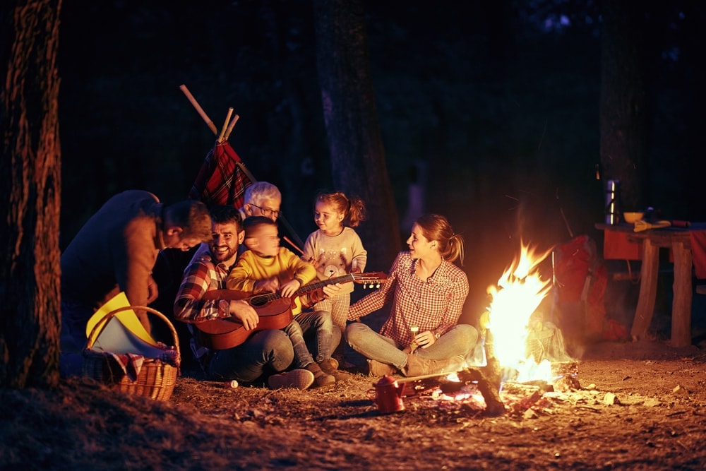 Family spending a night playing campfire games and singing