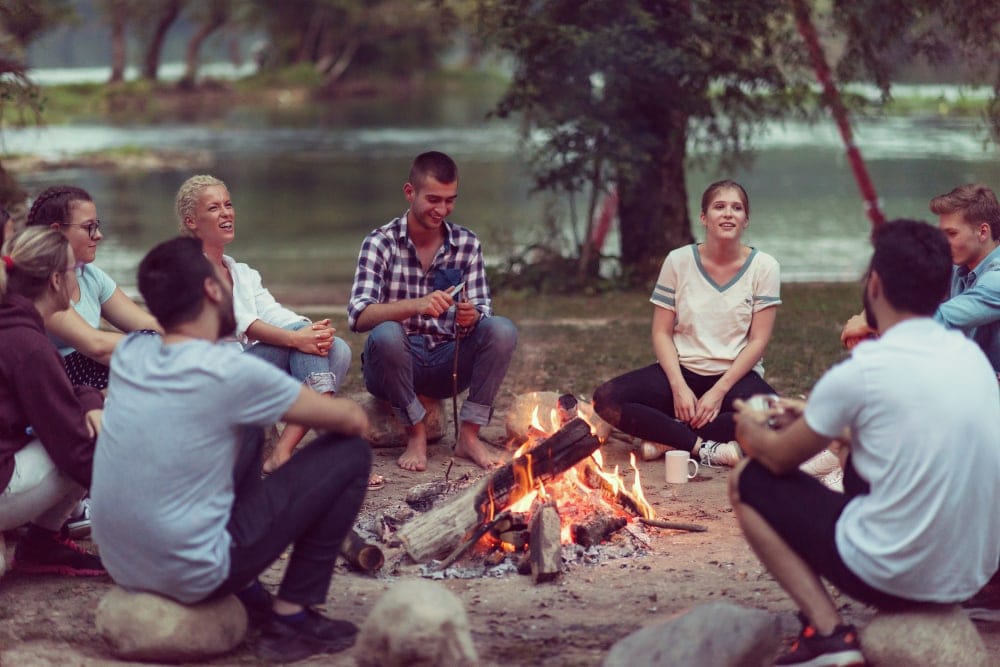 Group of friends hanging out and playing campfire games