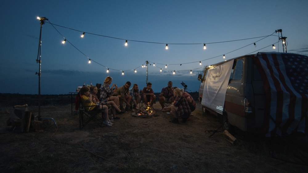Family and friends enjoying the night drinking and playing campfire games