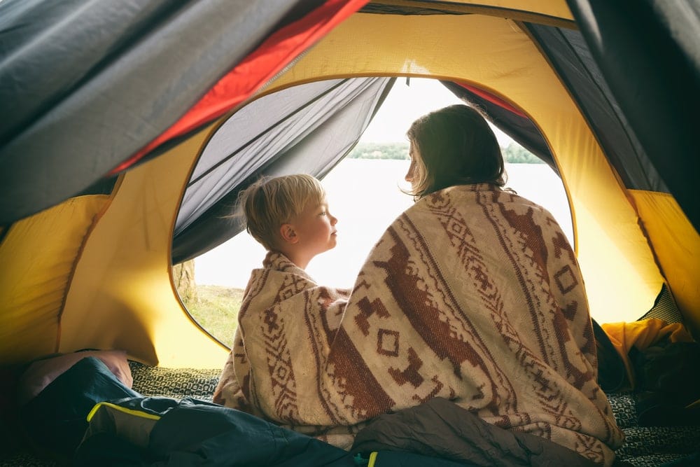 Mother and son inside a tent