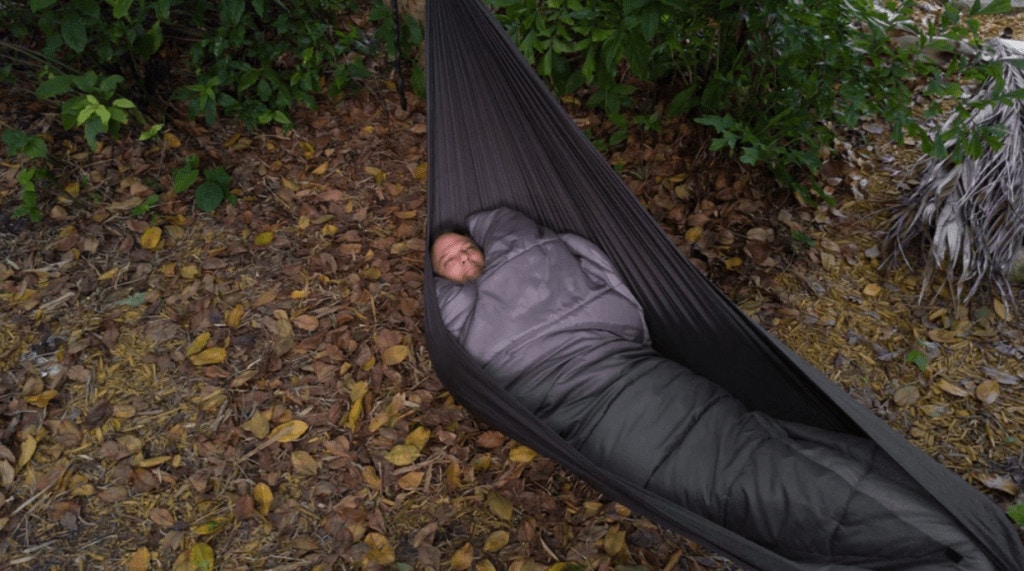 Ma sleeping with his quilt in a hammock