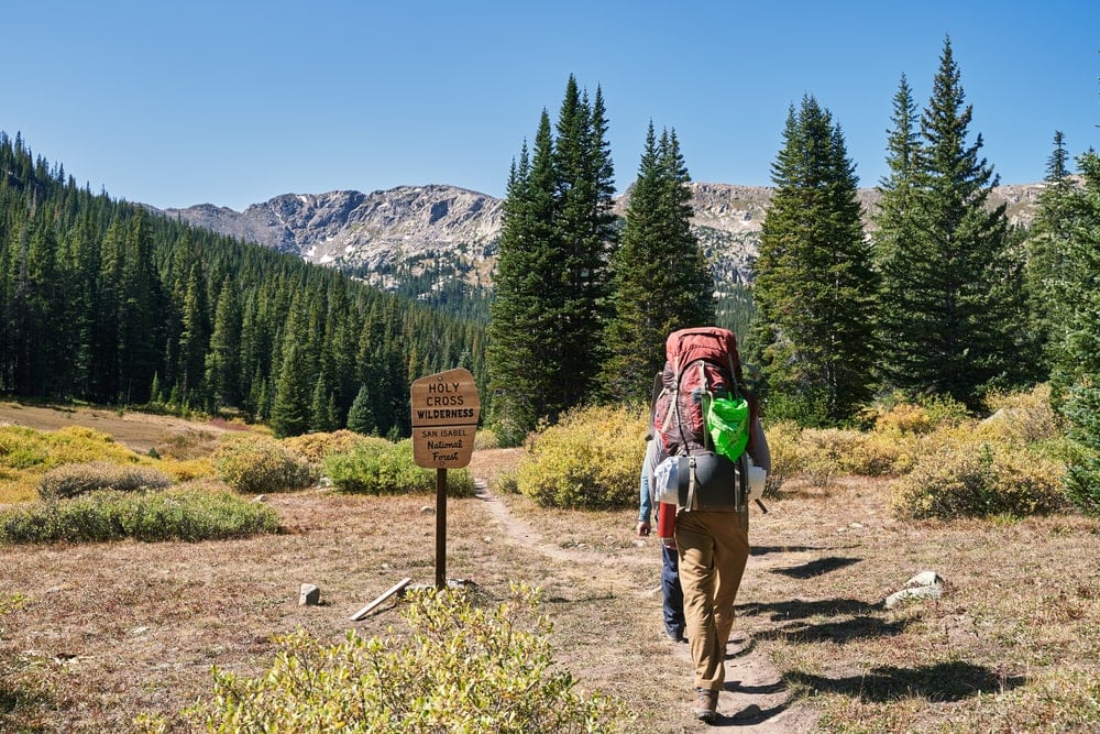 Two hikers passing holy cross wilderness
