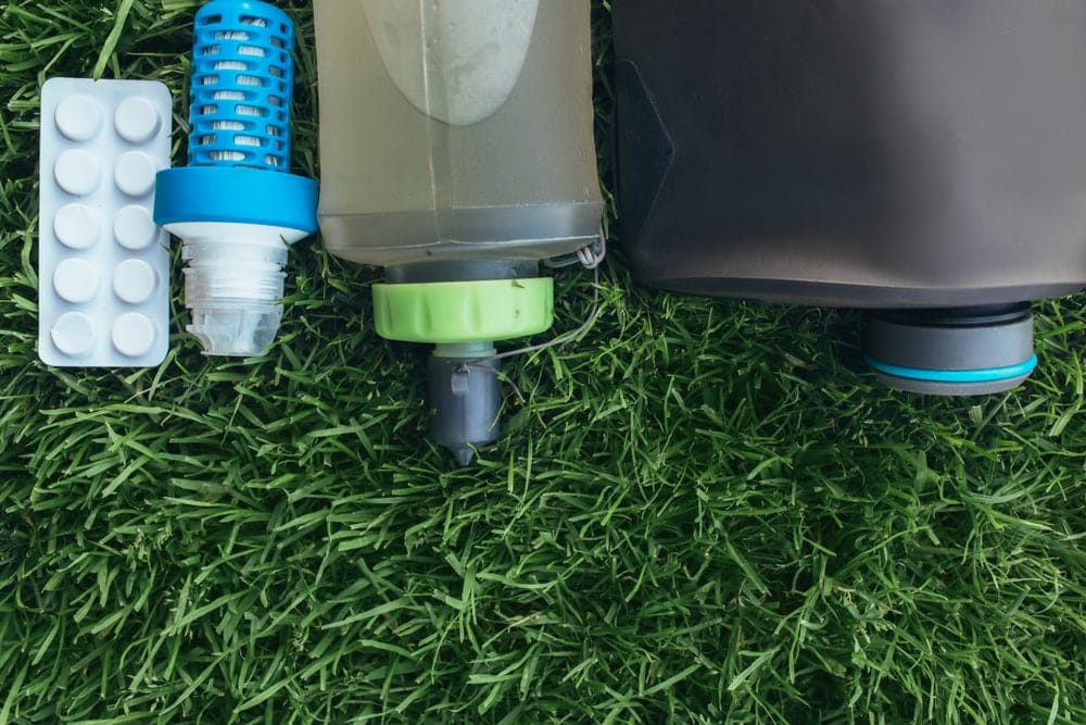 Water purification kit during for backcountry hiking that includes filter, tablets and a water bottle