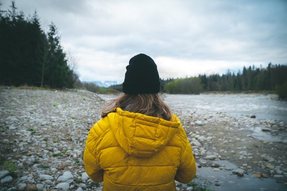 A backpacker wearing yellow jacket during backcountry hiking