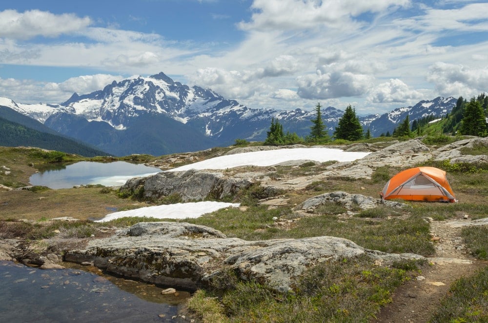 Camping tent in backcountry campsite. with mountain in the background