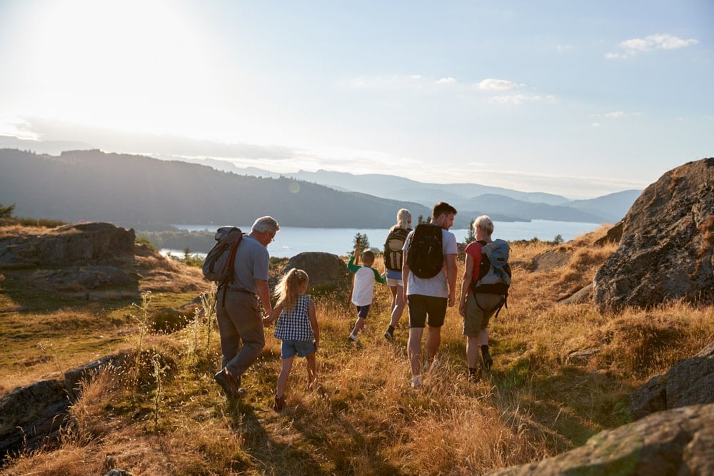 Family hiking on top of a hill