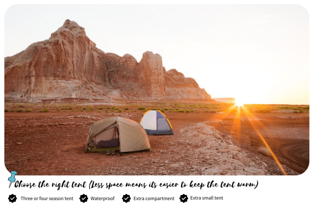 Two camping tents at the back of a mountain on a sunny day