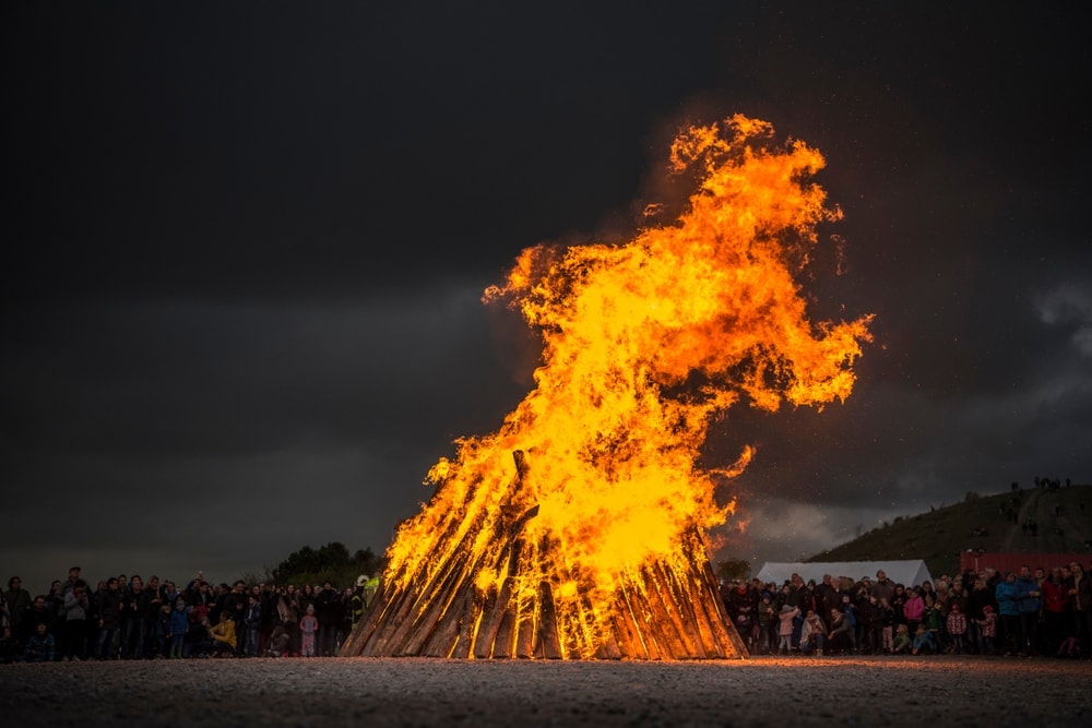 High and big bonfire surrounded by people