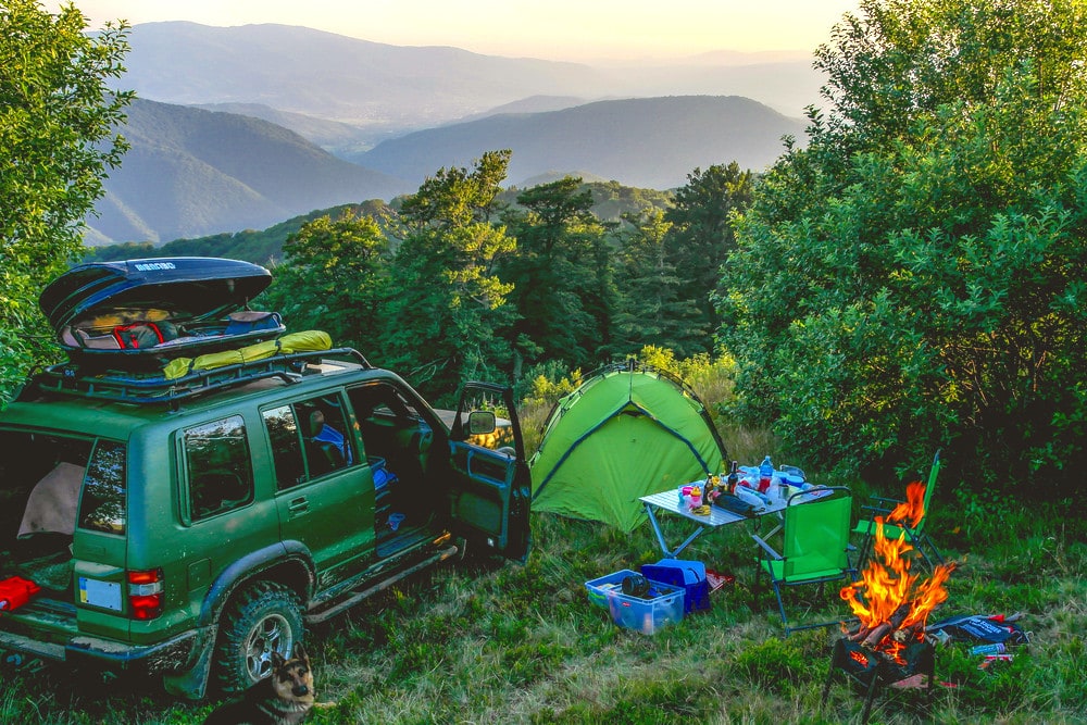 Car Camping in bear country with a camping table, campfire and a tent 