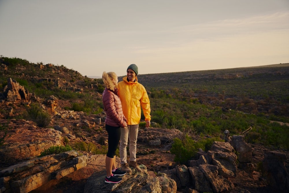 Man and woman smiling at each other on a hiking date