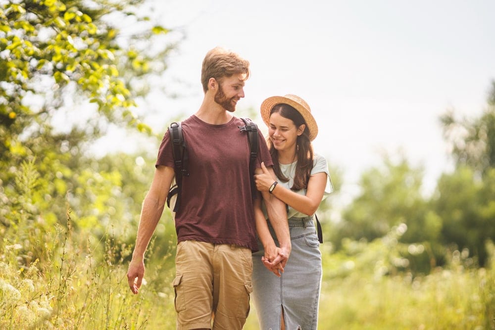 Couple holding hands on a hiking date