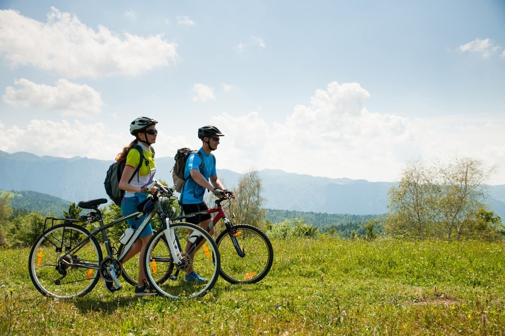 Couple walking with bicycles on a date