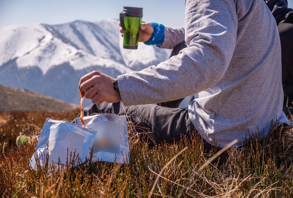 Hiker eating freeze dried food during resting