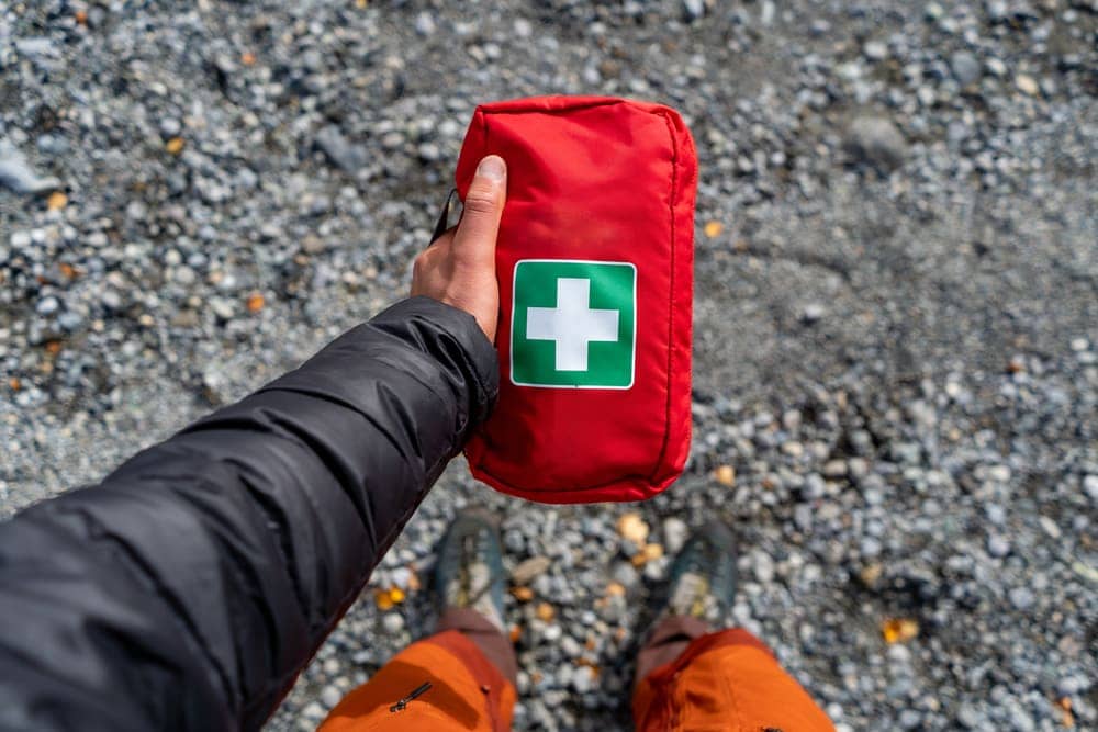 Man holding a first aid kit for hiking