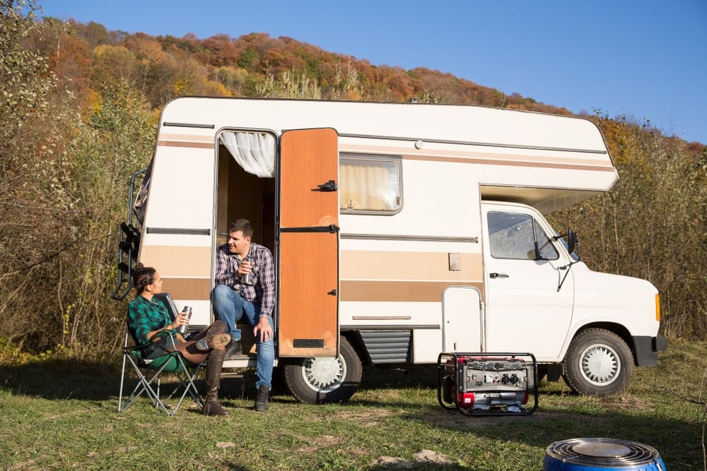 Camping portable generator outside a camper