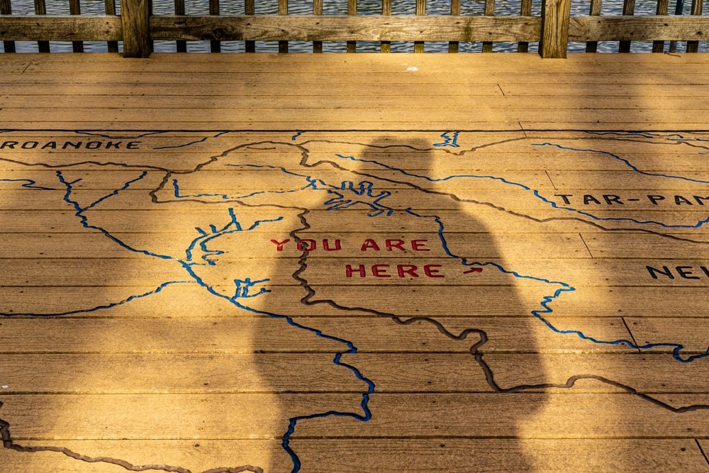 You are here trail sign with a shadow of a person