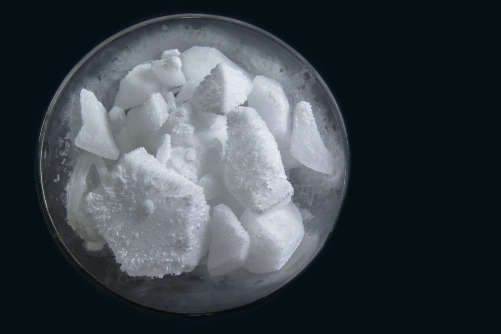 Dry ice smoking with vapor in a glass with black background