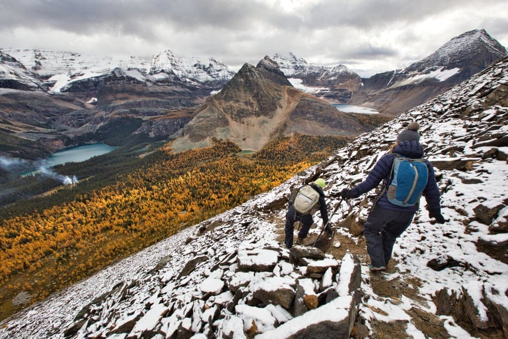 Hikers carefully scrambling down in the mountain