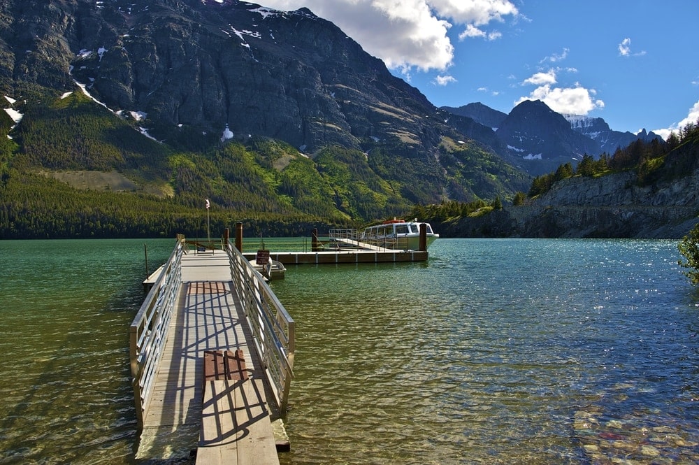 a tourist boat on a lake in Glacier National park
