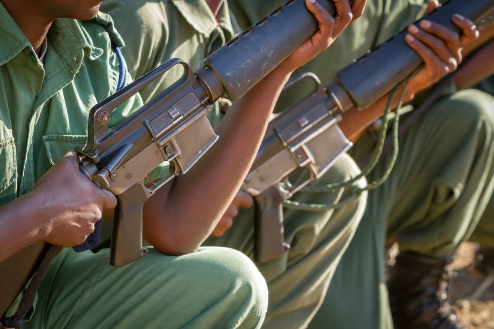 Group of men holding a gun