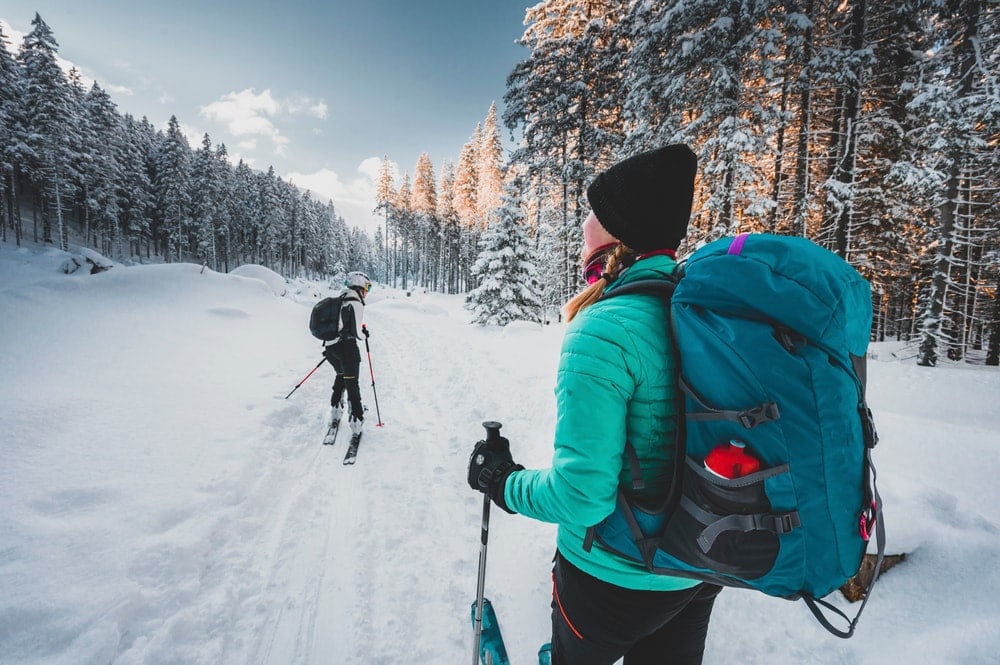 Two people enjoys hiking on winter