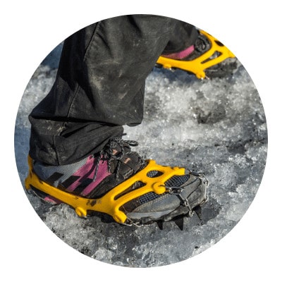 Spike shoes on ice during a winter hike