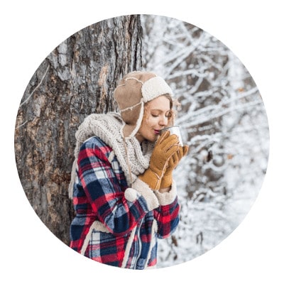 Woman drinking hot water on the woods
