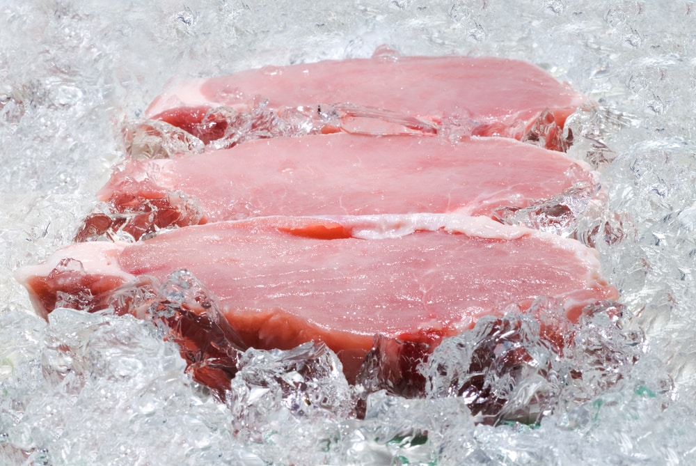 Raw pork surround in ice to keep it cold