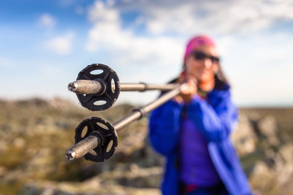 Woman showing off the bottom of trekking poles