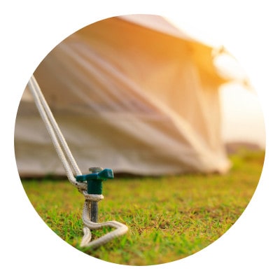 Camping tent being nailed on to the ground