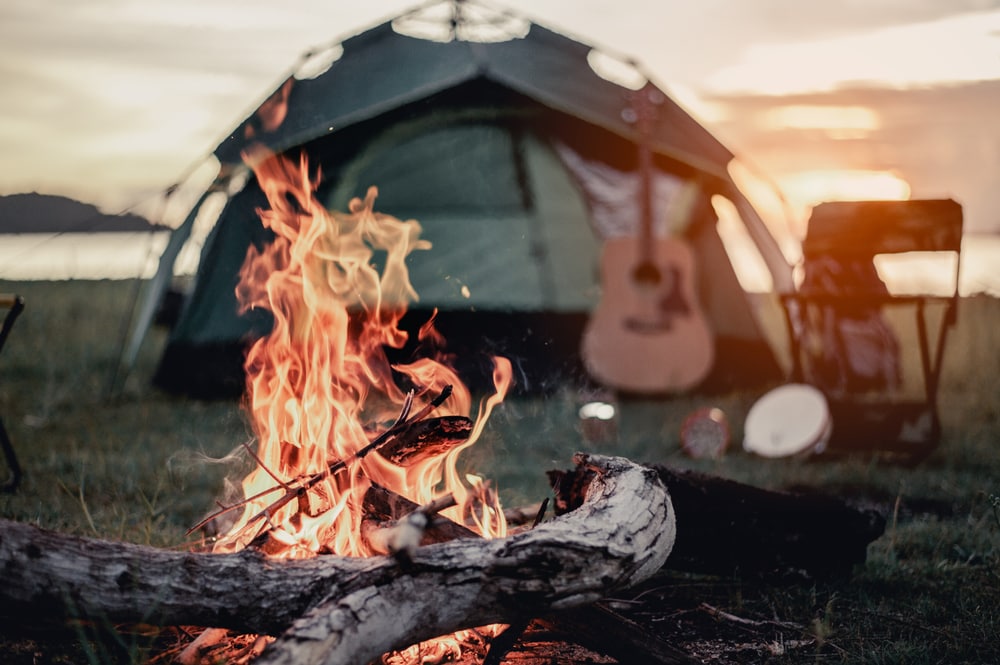 a campfire and tent during on a campground